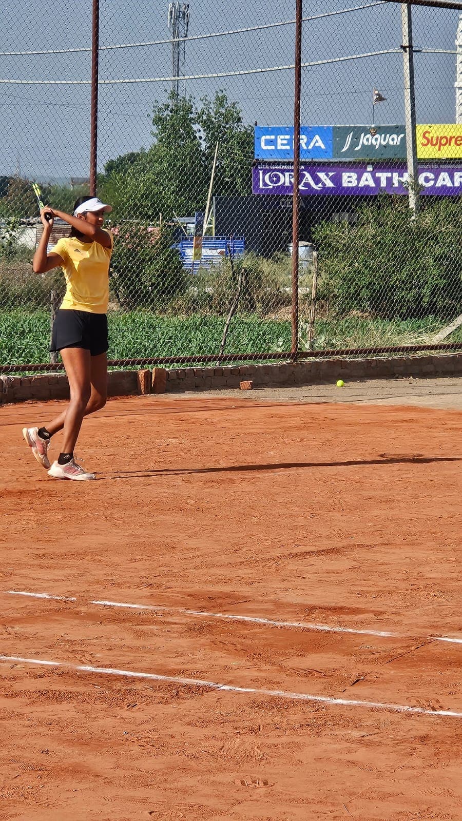 Head coach on court with tennis balls and city skyline