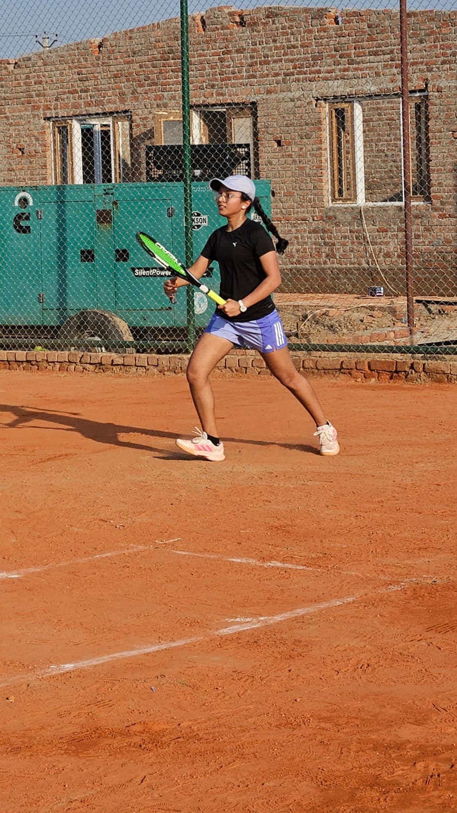 Player hitting a forehand on clay court